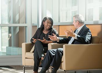 two business students sitting and talking